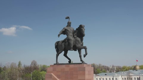 Bushkek, Kyrgyzstan - April 3, 2020: Aerial drone footage of monument of riding knight in centre of Bishkek at Ala-too square in Kyrgyzstan. Pixel texture. film grain texture.