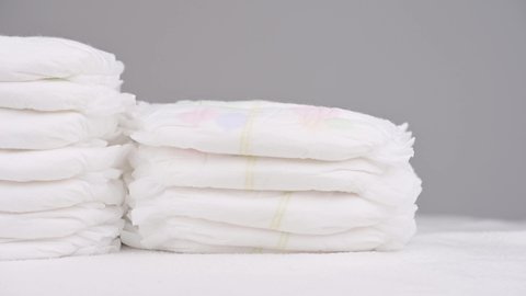 Pile of baby diaper panties diaper isolated on background, close-up, copy space, infant
