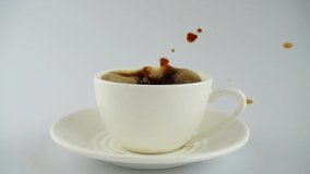 Falling sugar into a cup of coffee. Slow motion. - Powered by Shutterstock - Get 15% off with code: PIKWIZARD15