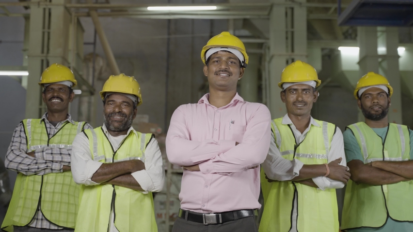 industrial employees with crossed arms standing by looking camera at factory - concept of leadership, successful workers and workforce. Royalty-Free Stock Footage #1088498627