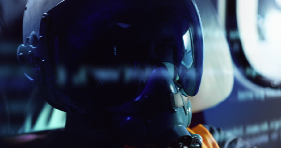 Close up shot of determined military armed forces soldier or pilot wearing protective helmet and oxygen mask inside cockpit of fighter jet airplane during aviation warfare or flight training routine. Royalty-Free Stock Footage #1088502687