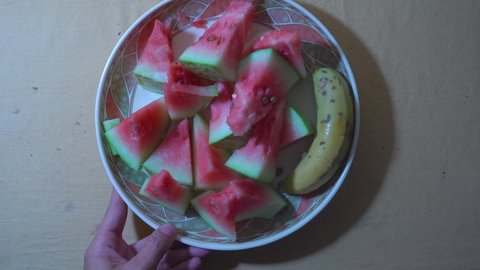Chopped watermelon slice and banana. One plate of food and fruits. One plate Chopped watermelon slice and banana in Summer.