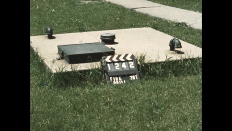 1950s: slate with "fire drill", fireman unscrews cap of fire hydrant on lawn in front of house, screws hose to hydrant, runs off, stairwell with railing
