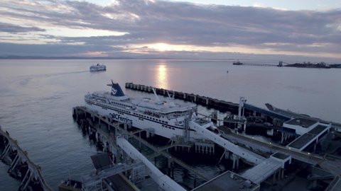 Vancouver , Canada - 03 15 2022: BCferries ferryboat docked at Tsawwassen Vancouver ferry terminal at sunset, Aerial drone view