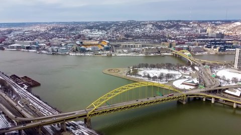 Pittsburgh , Pennsylvania , United States - 03 13 2022: Aerial View of Fort Pitt Bridge with Point state park, three rivers and heinz field in the background