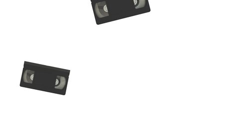 Retro video cassette tape falling down on white background