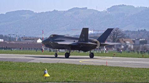 US fighter Lockheed Martin F-35 taking off from Swiss Air Force Airbase Emmen, Canton Lucerne, on a sunny spring noon. Movie shot March 23rd, 2022, Emmen, Switzerland.