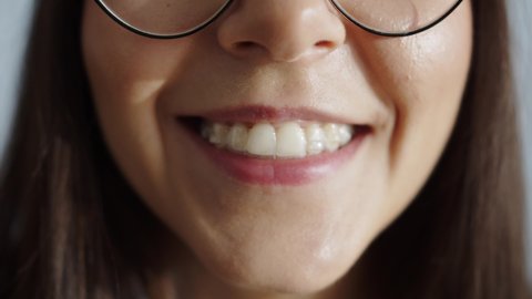 Close-Up View On Smile Young Woman With Invisalign Braces Sitting Alone In Home Smiling Looking At Camera. People And Style Concept. Clear And Removable Aligner Retainer Or Tooth Whitening System
