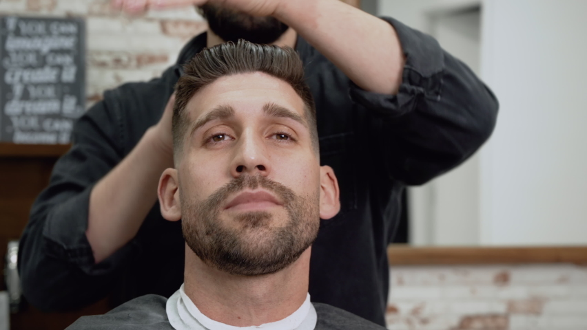 Barber shop. Man in barber's chair, hairdresser styling his hair. High quality 4k footage | Shutterstock HD Video #1088519657