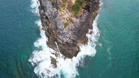 Aerial view top down of big waves crashing on rocks in dark blue ocean. Beautiful sea waves water texture. Drone view high quality 4k shot.Bird's eye view Travel and nature background concept