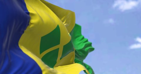Detail of the national flag of Saint Vincent and the Grenadines waving in the wind on a clear day. Saint Vincent and the Grenadines is an island country in the Caribbean. Selective focus. 