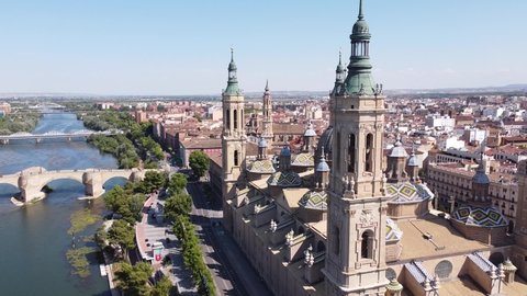 Zaragoza , Spain - 07 26 2021: Zaragoza, Aragon, Spain - Aerial Drone View (Fly Back) of Cathedral Basilica of Our Lady of the Pillar, Bridges and Ebro River