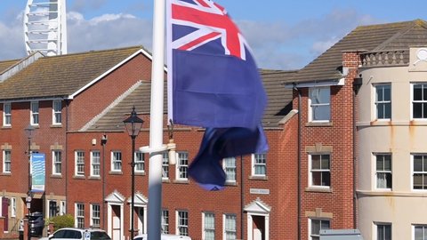 Flag of the Falkland Islands fluttering in the breeze in Portsmouth next to the square tower.