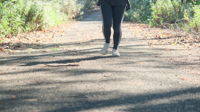 Female athlete sprained her ankle while practicing, holding her ankle in pain. Leg injuries from running accidents