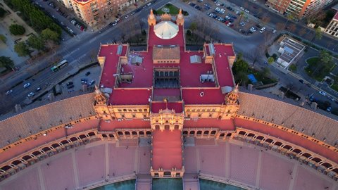 top down aerial view of Plaza de Espana in Seville at sunset, famous Seville landmark, high angle view of downtown Seville, drone shot of Seville skyline. High quality 4k footage