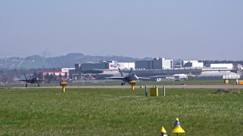 McDonnell Douglas FA-18 Hornet and Lockheed Martin F-35 taxiing at Swiss Air Force Airbase Emmen, Canton Lucerne, on a sunny spring noon. Movie shot March 23rd, 2022, Emmen, Switzerland.