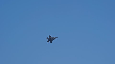 US fighter Lockheed Martin F-35 up in the air at Swiss Air Force Airbase Emmen, Canton Lucerne, on a sunny spring noon. Movie shot March 23rd, 2022, Emmen, Switzerland.