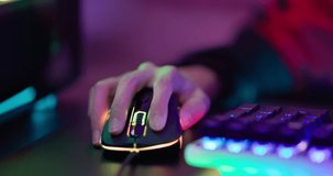 close up of pro cyber sport gamer hands play game with RGB keyboard and mouse
