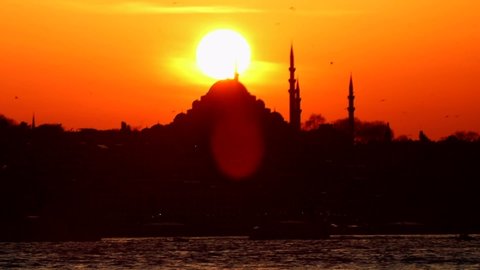 Ramadan background footage. Silhouette of Suleymaniye Mosque at sunset in Istanbul. Ramadan or kandil or laylat al-qadr or islamic background video. Noise included.
