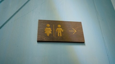 The sign of the men's and women's toilets on the wall. Gender division.