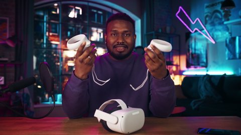 Stylish African American Man Recording a How To Video Review About Modern Virtual Reality Headset. Young Black Man Explaining New Features on Live Podcast on Social Media.