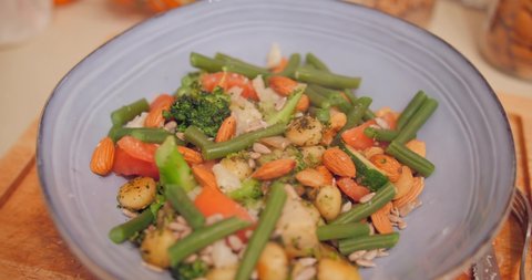Serving Of Italian Dish Gnocchi With Vegetables And Nuts. rack focus
