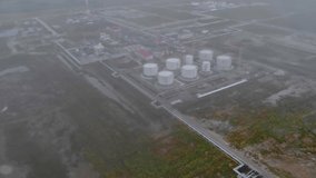 Drone flight over the oil depot covered with fog. Oil and gas production in Russia and Canada. Fuel crisis in the world. Increase in gasoline prices due to sanctions.