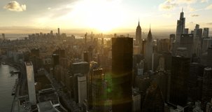 Aerial panoramic footage of cityscape with tall downtown skyscrapers. View against colourful sunset sky. Manhattan, New York City, USA