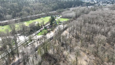 Cinematic 4K bird'-eye drone shot of flooding on the Duwamish, Green River Black Diamond Rd by the Neely Mansion in Auburn, King County Washington