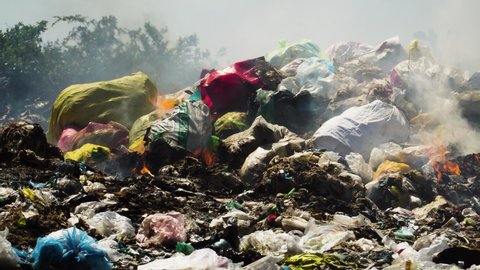 Air pollution by illegal burning pile of plastic trash landfill in Vietnam,