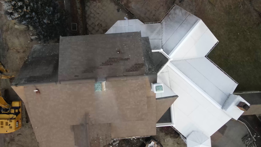 Ascending drone footage of house getting ready to be demolished. Drone raising footage