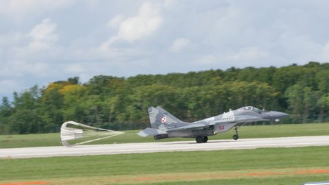 Udine Italy SEPTEMBER, 5, 2015 Russian made military plane lands with brake parachute opened. Mikoyan MiG-29 Fulcrum of Polish Air Force a fighter jet designed in Soviet Union during the Cold War