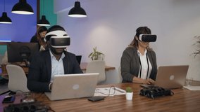 Business people wearing virtual reality glasses while working in modern creative space - Powered by Shutterstock - Get 15% off with code: PIKWIZARD15