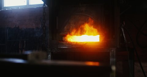 Kindled fire in the blacksmith's furnace. Close-up of the fire, the flames coming out of the holes in the furnace. There are no people in the video. 4k video, red komodo