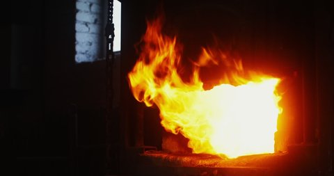 Kindled fire in the blacksmith's furnace, close-up. A strong flame breaks out of the furnace. There are no people in the video. 4k video, red komodo