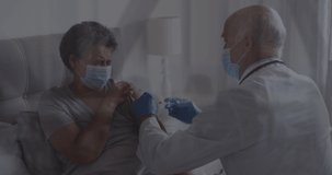 Animation of data processing over caucasian male doctor with face mask vaccinating. global medicine and data processing during covid 19 pandemic concept digitally generated video.
