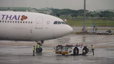 BANGKOK, THAILAND - NOVEMBER 11, 2017: Airbus A330 Thai Airways at Suvarnabhumi Airport. Airplane pushback by tug at international airport for takeoff