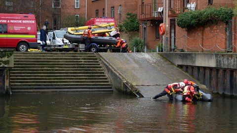 Norwich, Norfolk, United Kingdom. February 19, 2021. Norfolk Fire and Rescue Service and Urban Search and Rescue crews recover surface rescue boats, at Quayside on River Wensum, Norwich. 