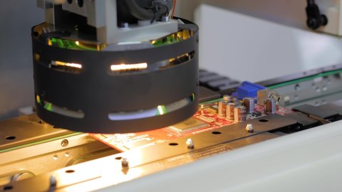 Close up view: automated visual optical inspection system for quality control of printed circuit board. Industrial, robotic, measurement, production, technology and manufacturing concept