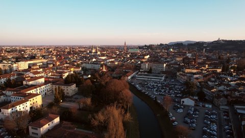 Aerial forward view of city of Vicenza with its river. Veneto region, Italy. Real time