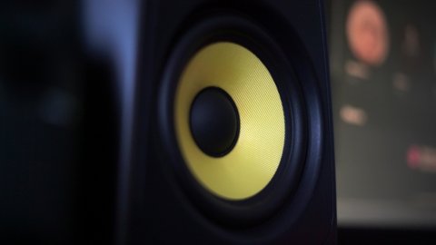 Blasting music on studio speakers. Close up of studio speaker bass subwoofering while listening song for music production, and jamming out studio monitors. Sound engineer playing loud music krk