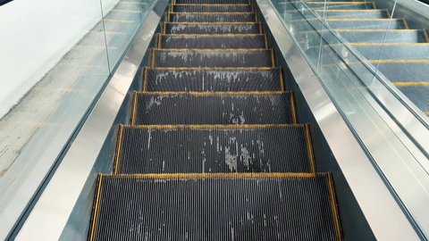 electric escalator Black stairs with yellow edges scrolling down