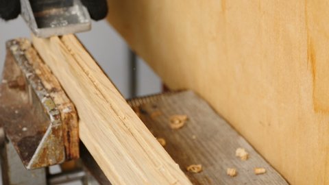 carpenter plans a wooden blank with a small planer