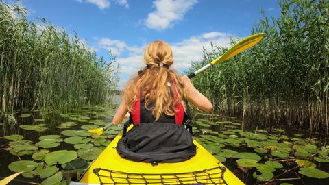Active young woman paddling on an kayak on in Finland. Family Sports. Summer. Travel. Tourism