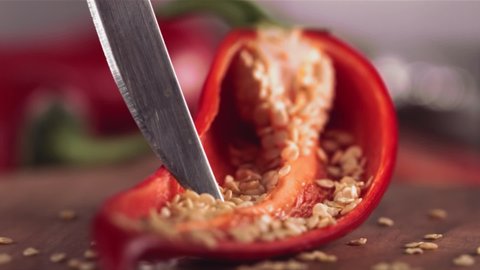 Slow Motion of Grains from Red Chilli Pepper with Knife