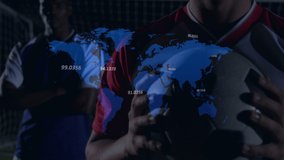 Animation of graphs and data over caucasian soccer player at stadium. finance, economy, professional sports and digital technology concept digitally generated video.