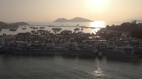 Aerial view of residential buildings in Cheung Chow Island at sunset. Residential buildings with seascape in Hong Kong.