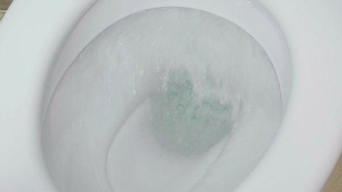 Close-up of flushing the toilet. Strong water pressure. Nobody