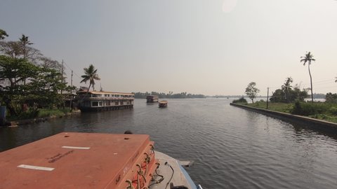 Ferry boat cruising on the Alleppey backwaters in India; static POV shot