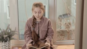 girl reading a book near the window - Powered by Shutterstock - Get 15% off with code: PIKWIZARD15